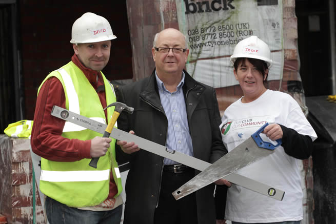 Volunteers at the Glentoran Community Build Day Rev. David Thompson (left) and Jodie Killops (right) demonstrate to Aubry Ralph, Chairman of Glentoran the work they have been doing to help Habitat for Humanity NI build homes on Templemore Avenue for families in East Belfast.