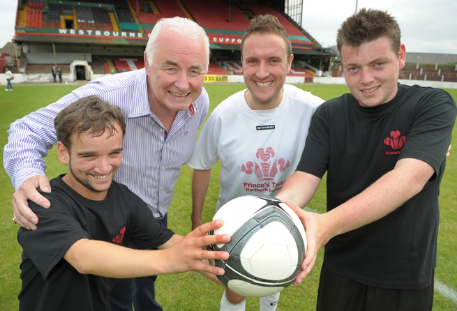 Young People Stephen Watson (left) and Christopher Haliday (right) demonstrate their football coaching skills to Chris Lyttle MLA (inside right) and Terence Brannigan, Chairman of Glentoran and board member of The Prince’s Trust (inside left) after participating in The Prince’s Trust ‘Get Started with Football’ programme